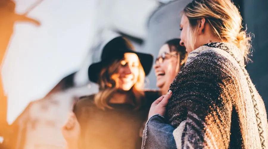 Three women laugh at a joke as sober friends
