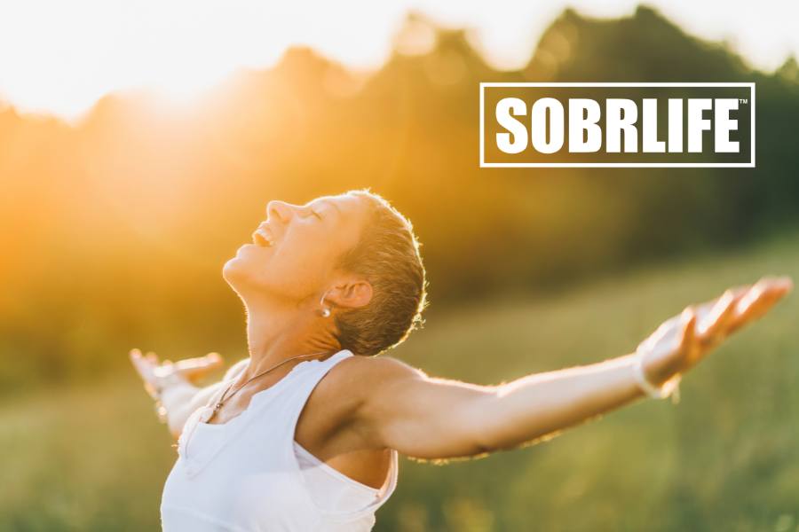 What is a spiritual awakening in recovery concept pic shows woman in the golden sun with arms spread out